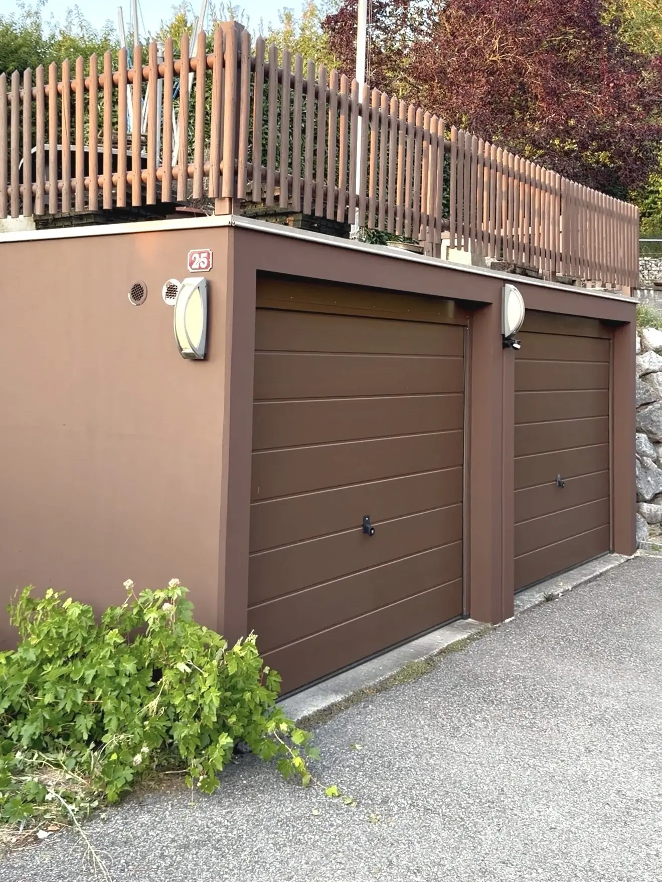 Deux portes de garage poncées puis remises en brun, le mur du garage dans le même ton